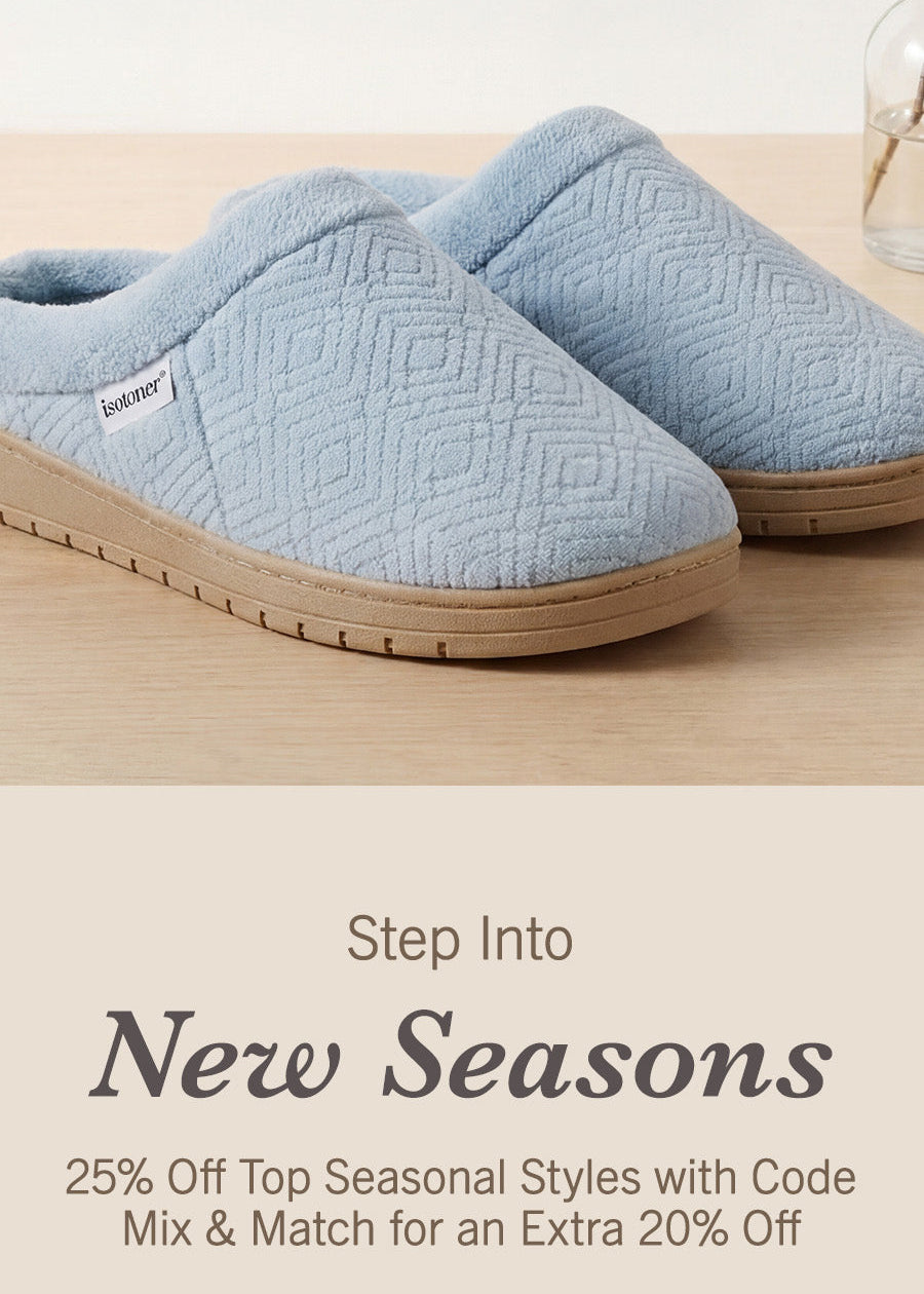 A pair of light blue quilted slip-on slippers with beige soles, displayed on a light wood surface with promotional text below reading 'Step Into New Seasons' and a 'Use Code REFRESH' button.
