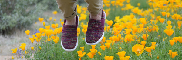 Women's Zenz Slip-Ons in a meadow of flowers