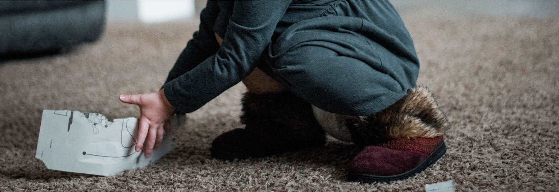 Girl's Wendi Boot Slippers on little kids feet playing on carpet