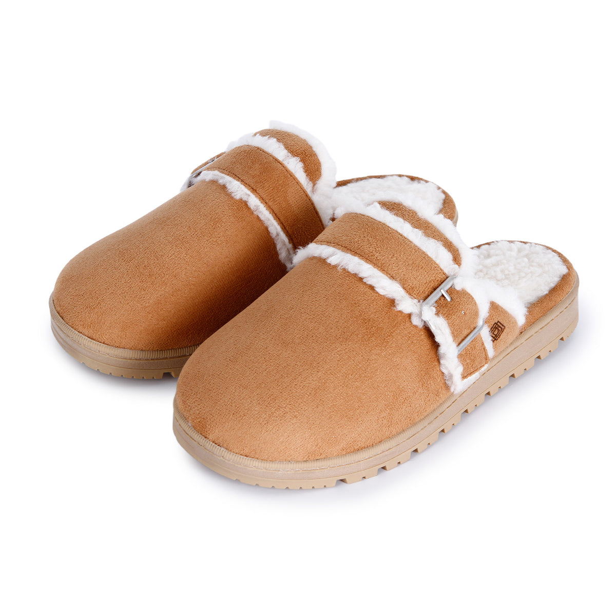 A tan suede clog-style slipper with white shearling lining and a silver buckle strap, shown on a plain white background.

