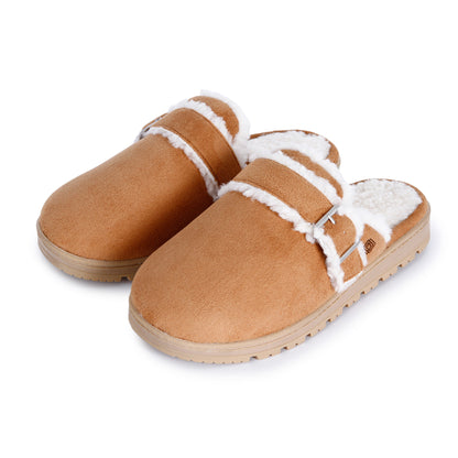 A tan suede clog-style slipper with white shearling lining and a silver buckle strap, shown on a plain white background.

