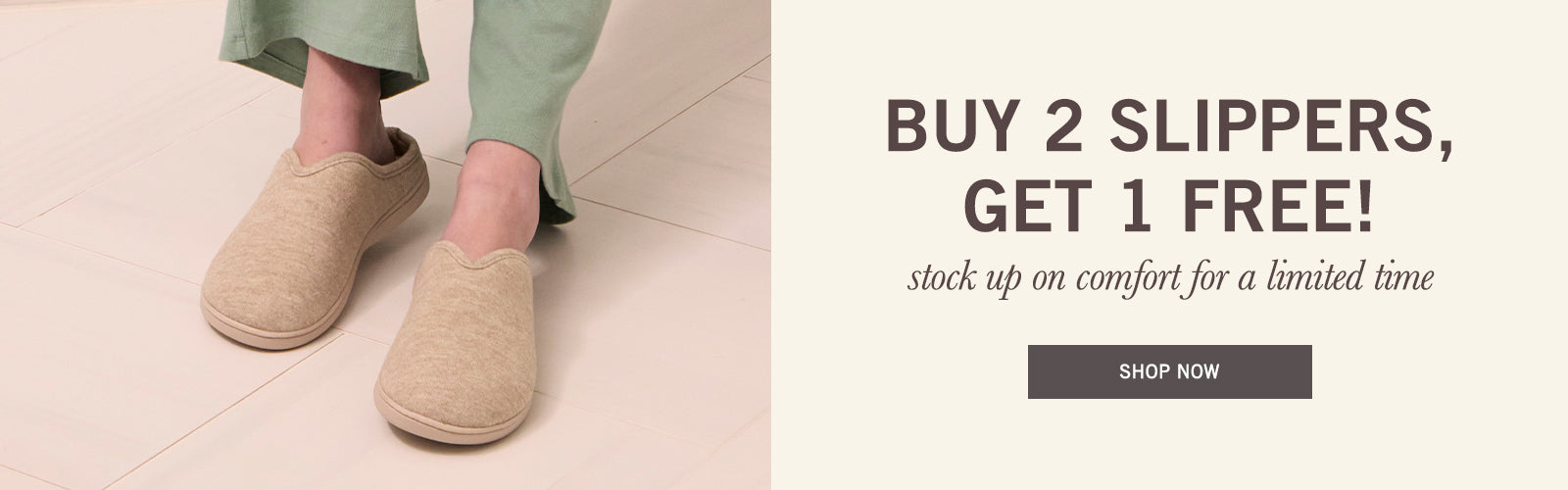 A promotional banner showing a person wearing a pair of beige slip-on slippers, with cropped green pants visible. The right side contains text reading 'BUY 2 SLIPPERS, GET 1 FREE!' with smaller copy and a 'SHOP NOW' button on a light beige background.