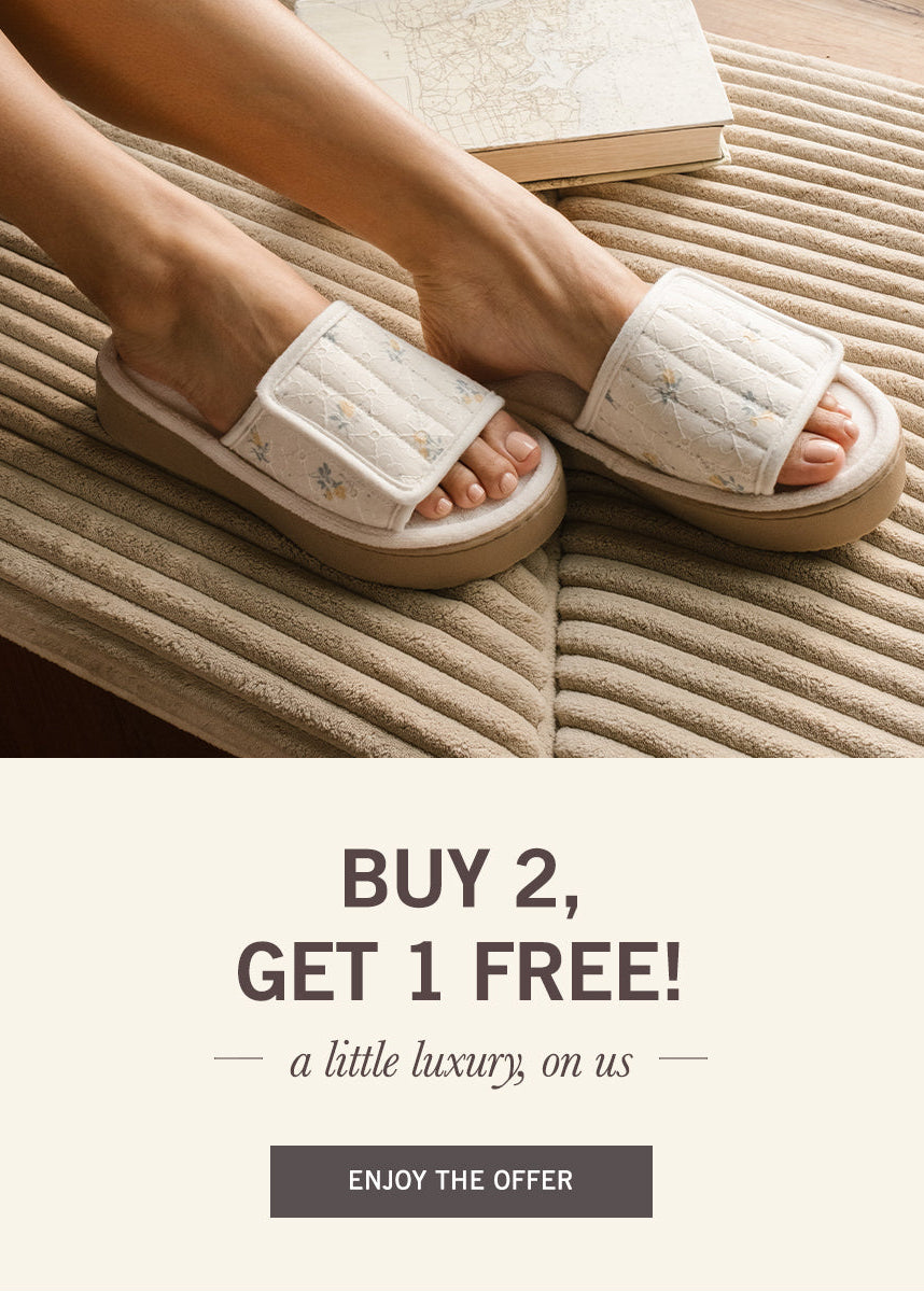 Beige slippers worn by a person on a textured surface with promotional text overlay.