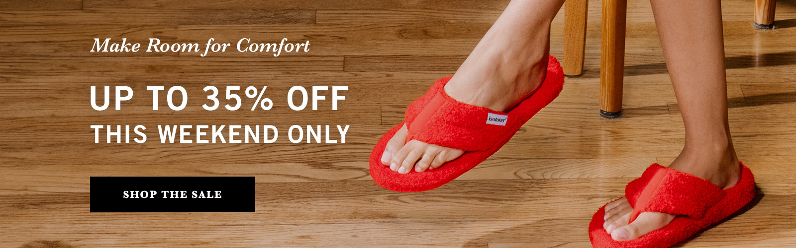 Red flip-flops on feet with promotional text for a sale on a wooden floor.