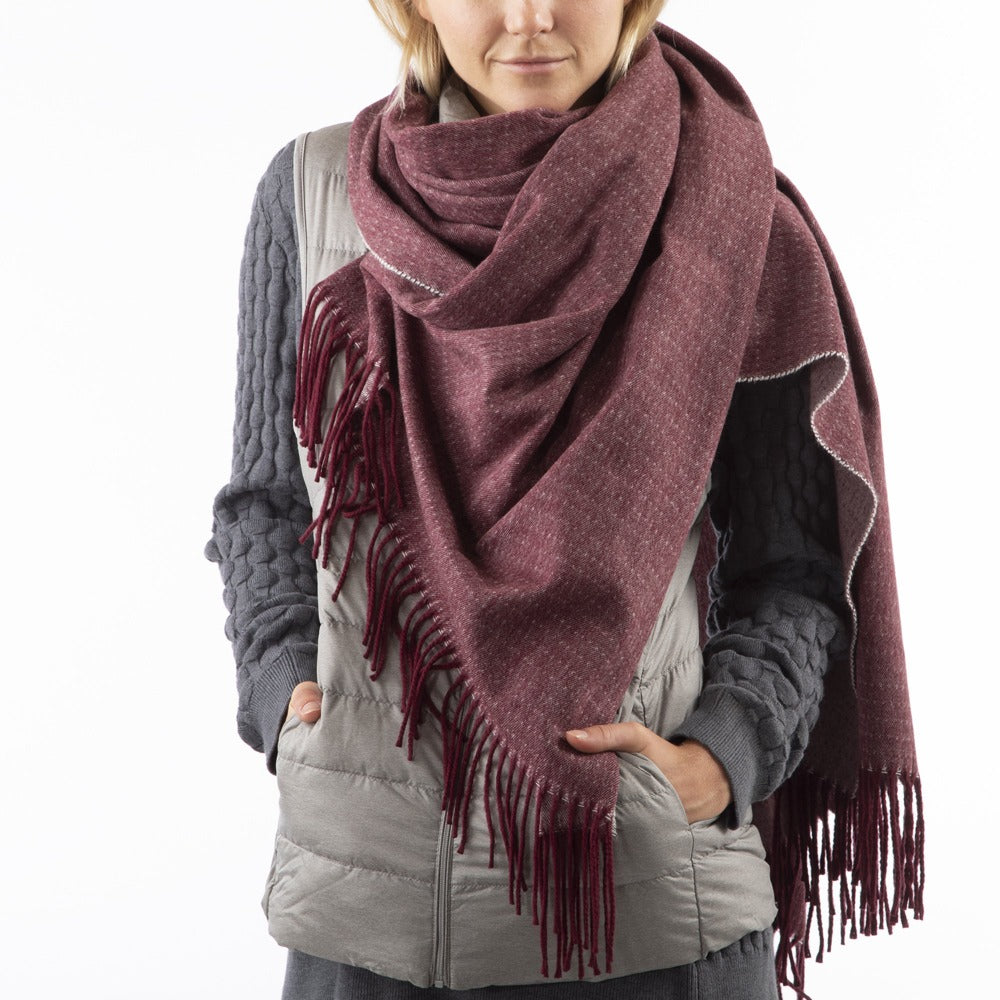 Women’s Recycled Scarf with Fringe in Henna Red on model. Wearing as a scarf. Front View.
