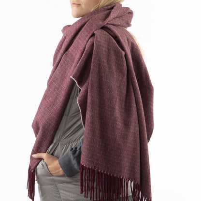 Women’s Recycled Scarf with Fringe in Henna Red on model. Wearing as a scarf. Side View.