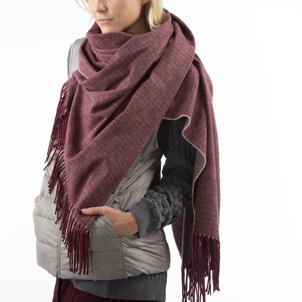 Women’s Recycled Scarf with Fringe in Henna Red on model. Wearing as a scarf. Open Side View. Oversized shot