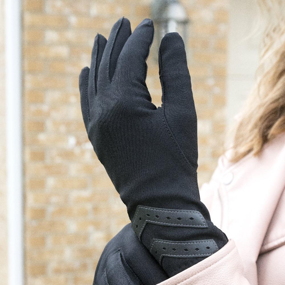 Women’s Heritage Chevron Spandex Gloves in Black on figure standing in front of a brick building tugging at the wrist of the glove