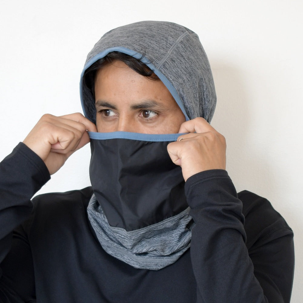 Men’s Antimicrobial Balaclava with Front Panel in Heathered Vintage Blue on figure. Model pulling the mouth piece up