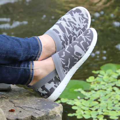 Woman wearing Zenz Harmony Slip on in Geo Print resting feet on a rock