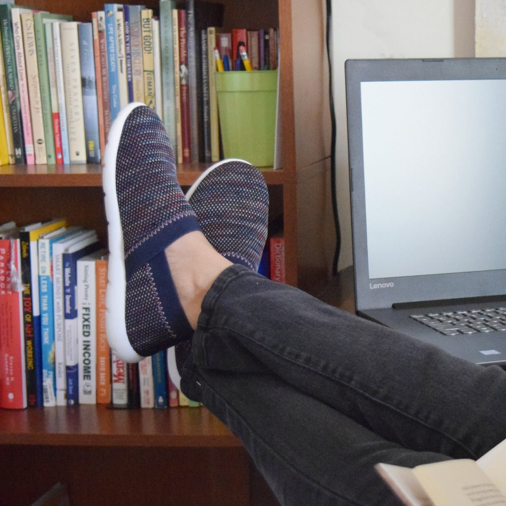 Woman working from home wearing Zenz harmony in navy with her feet up by her computer
