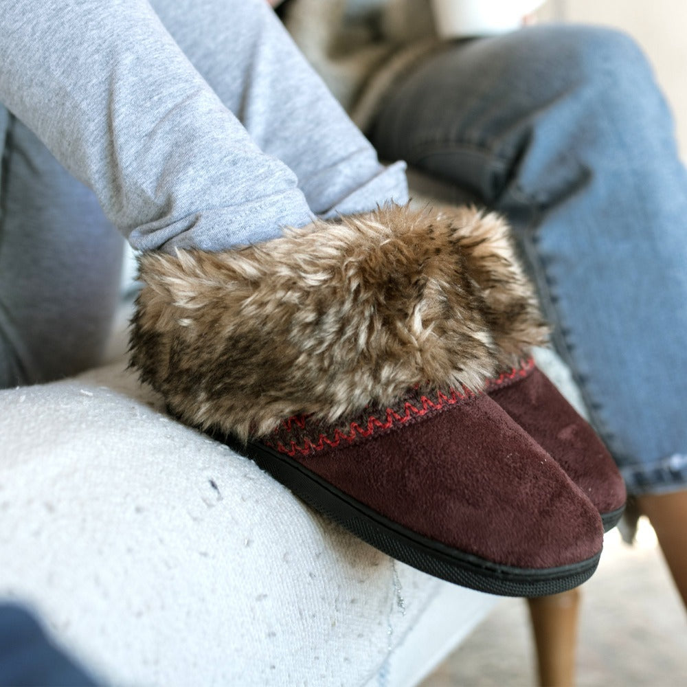 Isotoner Girls Wendi Slipper Boot in Henna Maroon on figure with models feet up on the side of couch